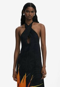 Black halter dress featuring a keyhole cutout, floral pattern, and vibrant orange accents at the hem. Smooth texture with a relaxed fit.