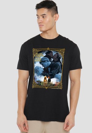 Man wearing black T-shirt showing "The Princess Bride" movie collage with couples kissing and text "Death cannot stop true love."