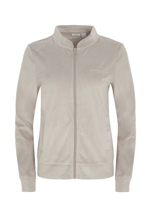 Jachetă din catifea cu fermoar, de culoare bej deschis. Are un guler ridicat, două buzunare laterale și un detaliu discret cu logo pe piept. Textură fină.