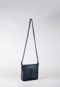 Leather crossbody bag in dark blue with a textured woven detail down the center, adjustable strap, and zip closure at the top.