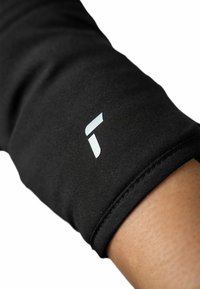 Black technical fabric arm sleeve featuring a small white logo. Close-up view shows smooth texture and subtle stitching details.