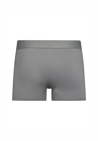 Bañadores de algodón gris con textura suave, que cuentan con una cinturilla elástica a juego y un diseño ajustado.
