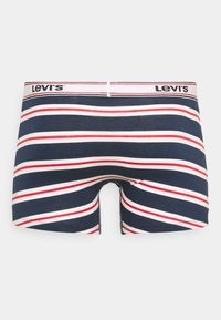 Boxer da uomo a righe blu navy con righe bianche e rosse alternate. La cintura elasticizzata presenta il logo "Levi's". Realizzati in un morbido tessuto elastico.
