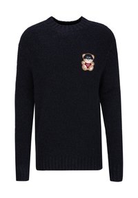 Dunkelblauer Strickpullover mit Rundhalsausschnitt, gerippten Bündchen und Saum. Hat ein gesticktes Bärenpatch mit "19V69" und "Après Ski."