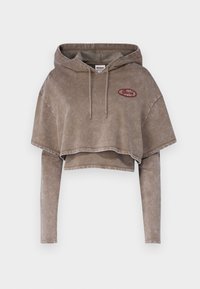 Zkrácená béžová mikina s dlouhými rukávy, měkká textura, kapuce na šňůrku a vyšívaná nášivka loga v borůvkové barvě na přední straně.