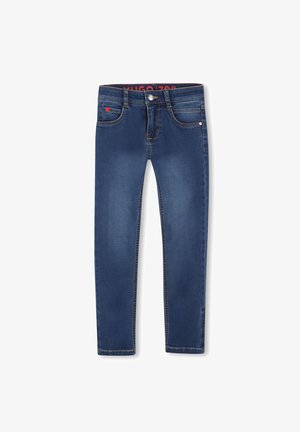 Strakke spijkerbroeken van donkerblauwe denim met subtiele vervaging, voorzien van een knoopsluiting, voorzakken en oranje stikselaccenten.