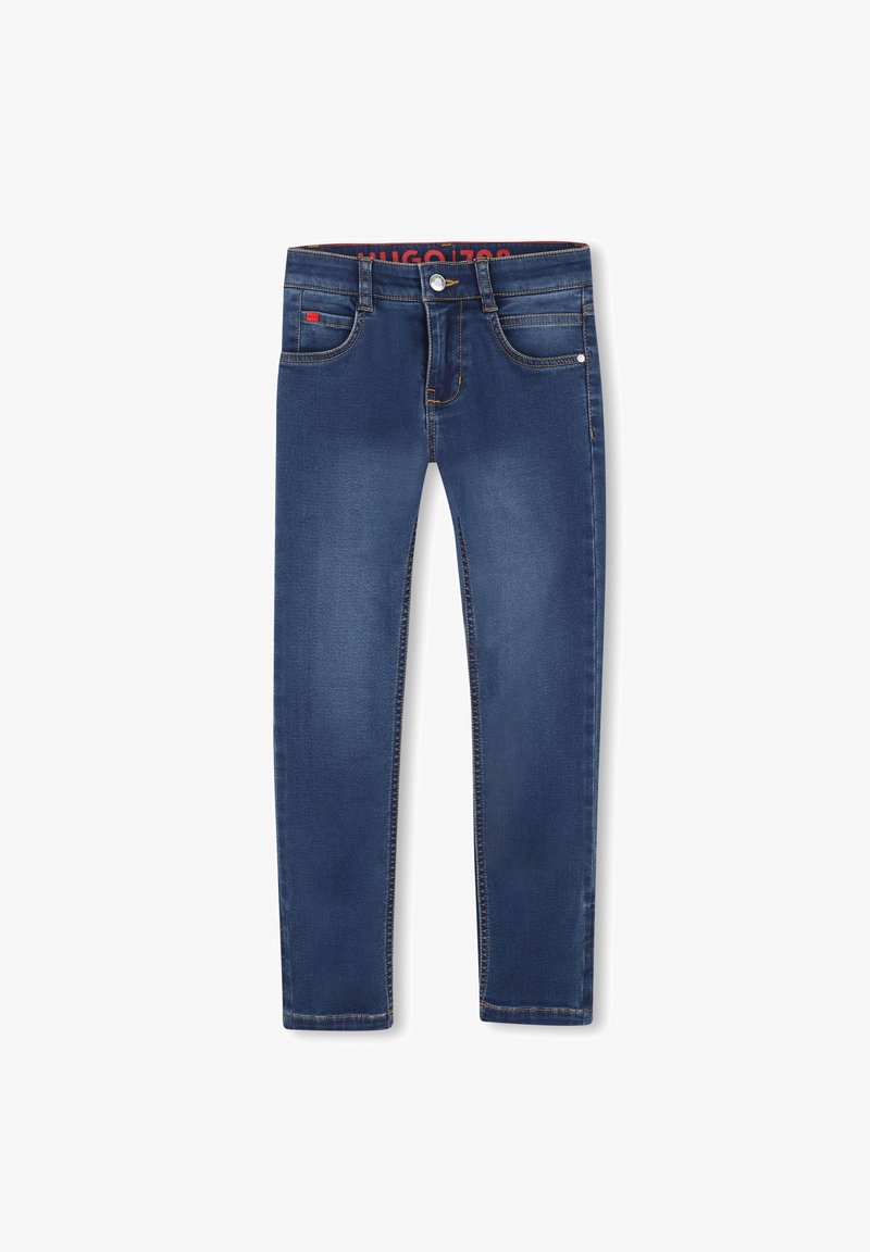 Jeans ajustados de denim azul oscuro con un ligero desvanecido, que cuentan con un cierre de botón, bolsillos delanteros y detalles de costura en naranja.