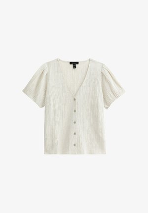 Witte textuur blouse met korte mouwen, een V-halslijn en vijf decoratieve knopen aan de voorkant. Puffmouwen en zachte, gekreukte stof.