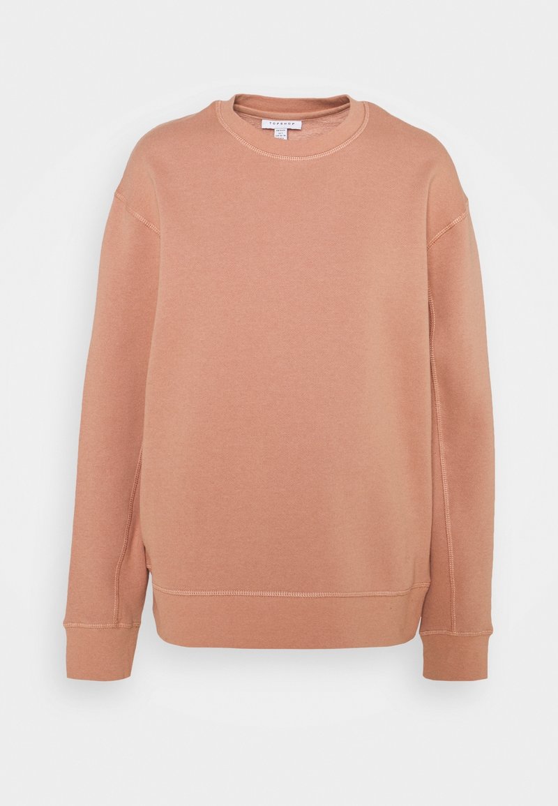 Sweat-shirt couleur pêche en mélange de coton doux, avec col rond, manches longues et poignets côtelés ornés de détails de surpiqûres visibles.