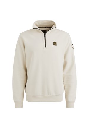Pull léger beige fabriqué en matériau doux, doté d'un col zippé quart, de poignets côtelés et d'un petit logo sur la poitrine. Design épuré et minimaliste.