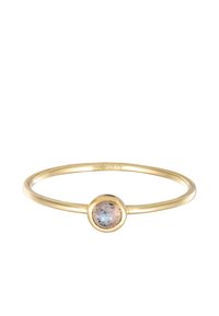 Guldfarvet armbånd med en central, rund, iriserende sten med spragler, glat tekstur og et minimalistisk design.