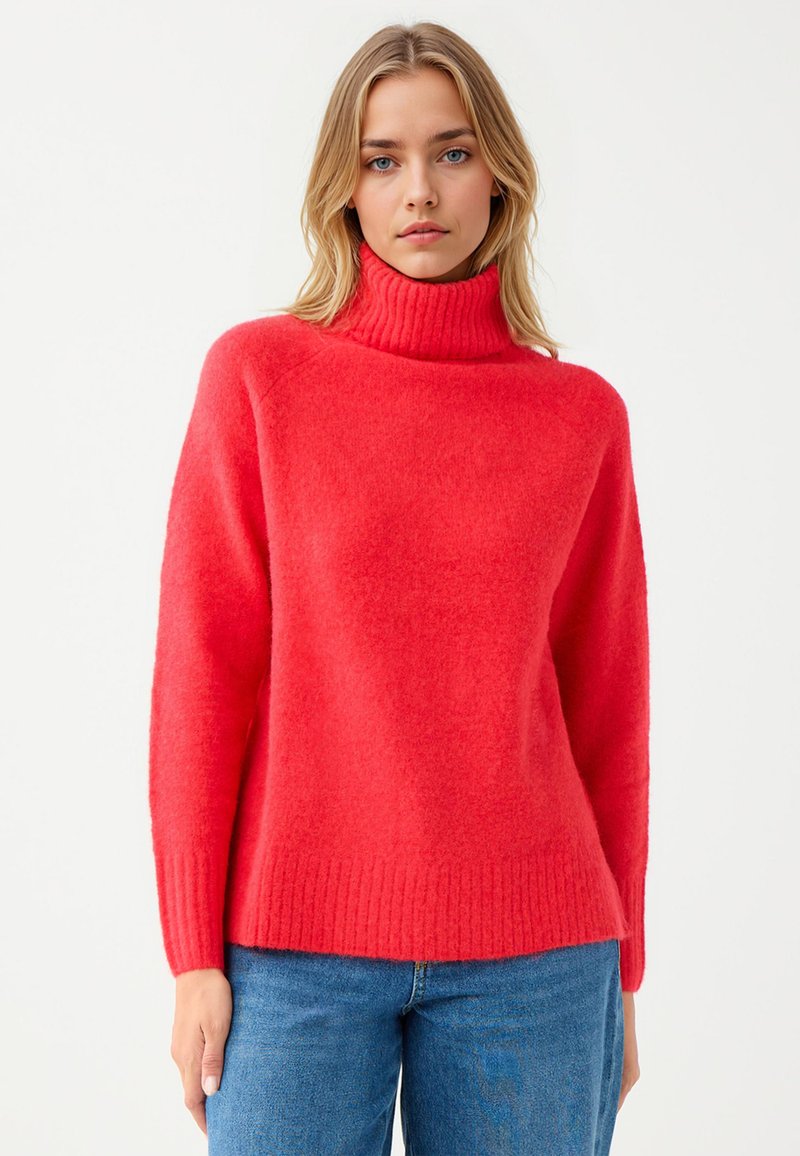 Czerwony sweter typu golf wykonaną z miękkiego, puszystego materiału; ma żebrowany kołnierz i dół, ma luźny krój oraz długie rękawy.