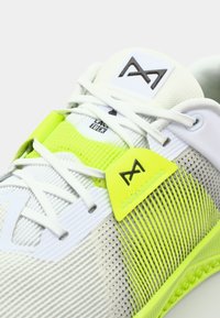 Lightweight athletic shoe in white mesh with fluorescent yellow accents, featuring textured panels and a logo patch on the tongue.
