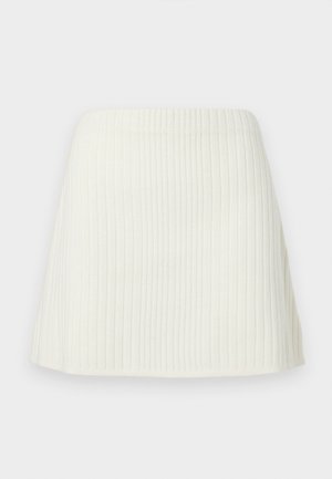 Balta, trumpa, nertinė mini sijonas su aukštu liemeniu ir lengvu išplatėjimu ties apatine dalimi.