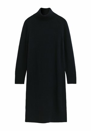 Svart genserkjole laget av myk strikket stoff. Har lange ermer, ribbestrikkede mansjetter og sidespalter for bedre bevegelse.