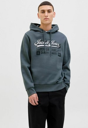 Sudadera con capucha en mezcla de algodón verde oscuro, con un estampado gráfico en blanco y negro en el frente, puños acanalados y un corte relajado.