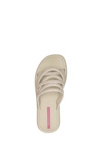 Beige sandal med fyra tunna horisontella remmar och en rosa etikett på fotbädden som säger "Ipanema Sempre Nova."