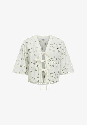 Cardigan court blanc avec motifs floraux découpés, manches courtes et trois attaches nouées à l'avant.