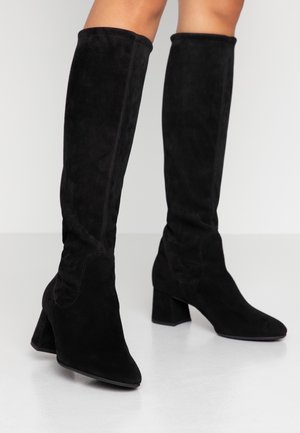 Black suede over-the-knee boots with a pointed toe and block heel. Features seamless design and smooth texture, suitable for various outfits.