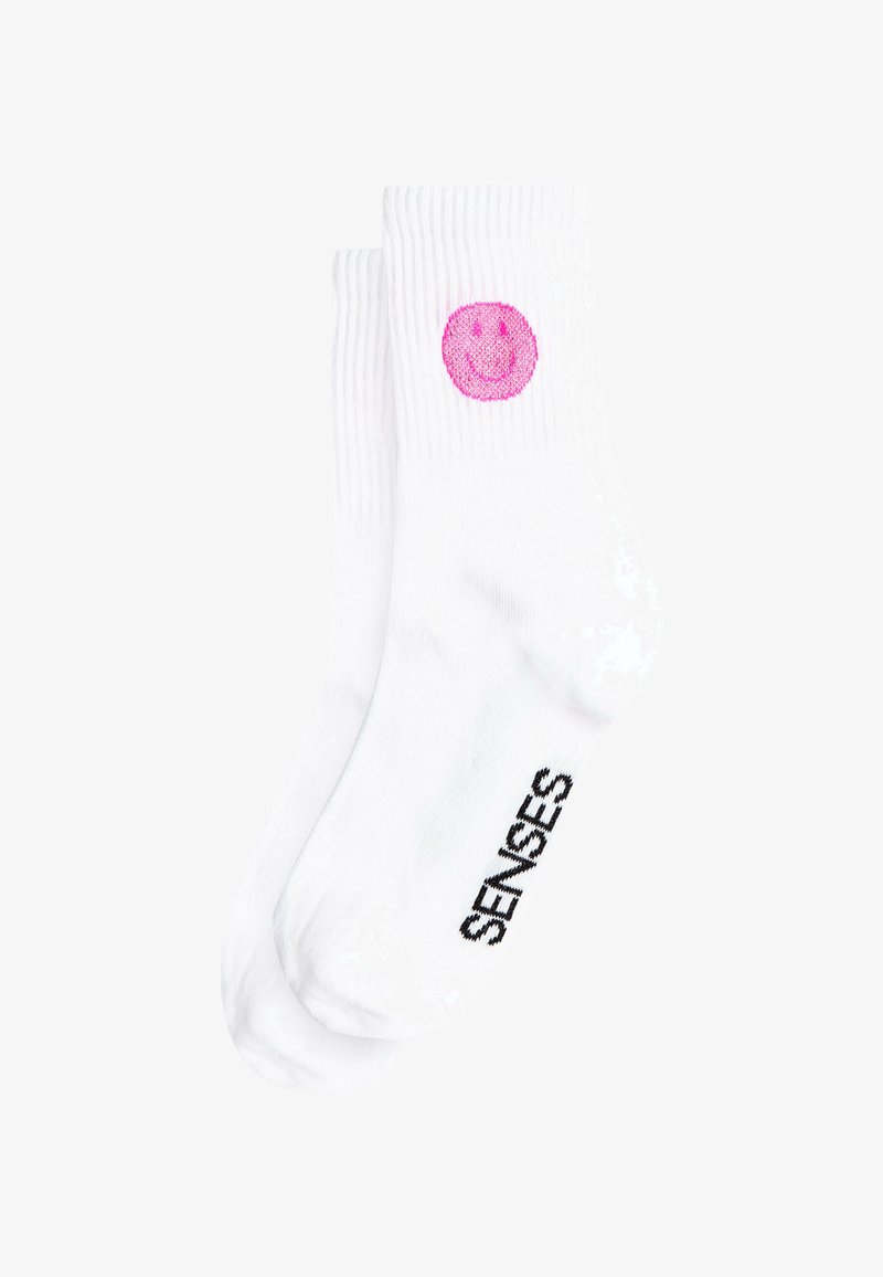 White cotton socks featuring a pink smiley face graphic and black "SENSES" text on the side, with ribbed texture and ankle length.