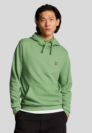 Green hoodie with a kangaroo pocket, drawstring hood, and a small yellow butterfly logo on the chest. Made of soft fabric.