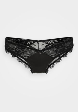 String noir en dentelle avec une taille en dentelle transparente, des bords festonnés et un panneau central lisse avec un accent décoratif à l'avant.