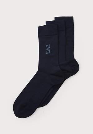 Navy cotton socks set of three, featuring a ribbed cuff and subtle embroidered logo detail. Smooth texture and classic design.