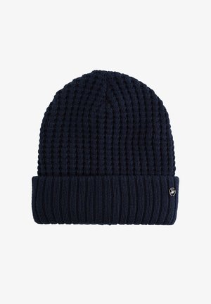 Mornarica pletena kapa s rebrastom teksturom, preklopnim rubom i malim logotipom sa strane. Izdržljiv materijal za toplinu i udobnost.