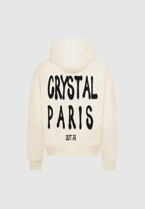 Kremowa bluza z kapturem z dużym czarnym nadrukiem na plecach, na którym widnieje napis "CRYSTAL PARIS" oraz "DEPT.75" poniżej. Posiada przednią kieszeń typu kangur oraz kaptur.