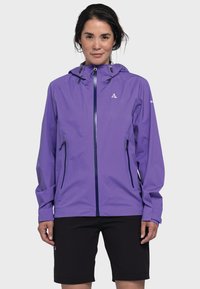 Lila wasserdichte Jacke mit einem Frontreißverschluss, verstellbarem Kapuzen, und zwei Seitentaschen. Strukturiertes Gewebe, entworfen für den Außeneinsatz.