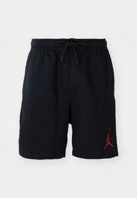 Sorte shorts lavet af blødt stof, med en elastisk linning og snøre, samt et rødt Jumpman-logo på nederste venstre ben.