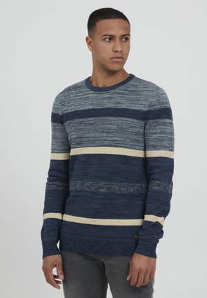 Navy and light blue striped sweater with textured knit, round neckline, and contrasting cream stripes. Slim fit with visible stitching details.