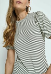 Striped short-sleeve top featuring a round neckline, made from soft fabric with black and white horizontal stripes, and subtle puff sleeve detail.