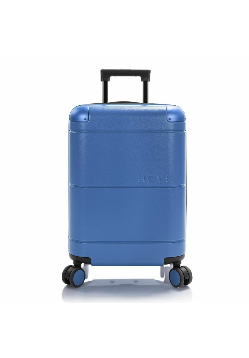 Valise rigide bleue avec une finition texturée, deux roulettes lisses, une poignée télescopique et un logo de la marque en relief à l'avant.