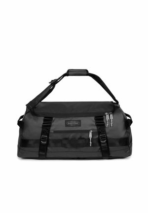 Bolsa de lona negra con una tela duradera, correa de hombro ajustable, dos bolsillos con cremallera y acentos de cinta para un soporte adicional.