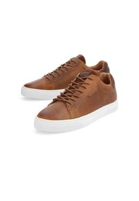 Baskets en cuir marron avec une finition lisse, dotées de semelles en caoutchouc blanches, d'un bout rond et de lacets plats, conçues pour un usage décontracté.