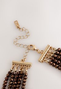 Gold-tone chain with brown faceted beads, featuring a lobster clasp and rectangular bar accents for added design detail.