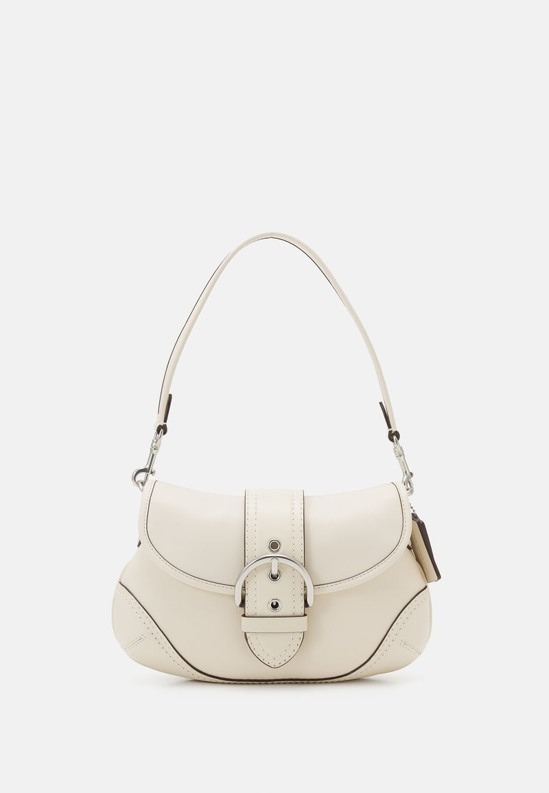 Cream leather handbag with a curved shape, silver buckle detail, and short strap. Features stitching accents for added texture.