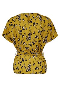 Blusa gialla con motivo floreale navy, maniche corte, cintura regolabile e dettagli sul retro a forma di chiave. Tessuto dall'aspetto liscio.