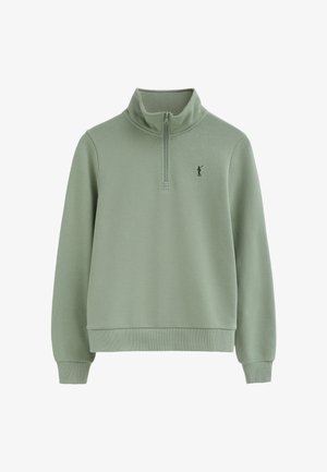 Jasnozielona bluza z półzamkiem przy kołnierzu i małym wyhaftowanym logo golfisty na lewej piersi.