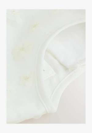 Garbato bianco con motivi floreali in un tessuto trasparente, caratterizzato da morbide trame e un collo rotondo. Il bordo è rifinito con cuciture.