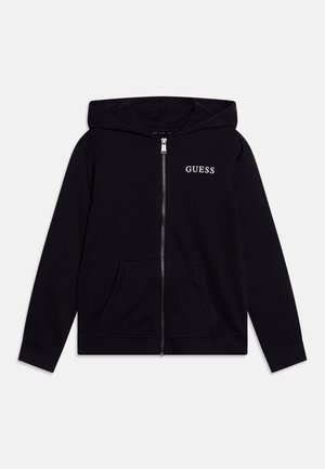 Black zip-up hoodie with front pockets, hood, and white "GUESS" logo on the left chest, displayed on a plain background.