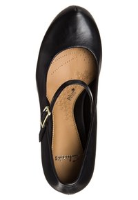Chaussure Mary Jane en cuir noir avec une semelle intérieure rembourrée couleur beige, une bride à boucle et un embout arrondi, photographiée vue de dessus sur un fond blanc.