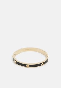 Gold-tone bangle bracelet featuring a black enamel inlay and three decorative studs. Smooth texture with a circular shape and clasp closure.