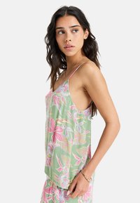 Floral-patterned green tank top with pink and white accents, featuring thin straps and a relaxed fit, made from lightweight fabric.