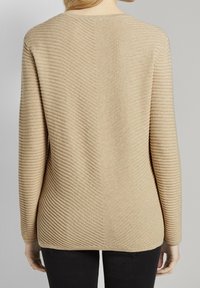 Beige geripptes Sweater mit einem Zickzackmuster, langen Ärmeln und einer lässigen Passform. Die Textur ist weich und hat einen subtilen Glanz.