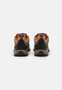 Brown waterproof hiking shoes with black accents, mesh panels, and orange details; defined heel and textured rubber outsole.