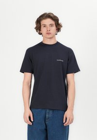 Dark navy cotton t-shirt with a crew neck, short sleeves, and a small white logo detail on the left chest. Classic fit and smooth texture.