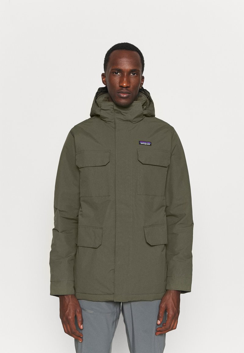 Olive green parka jacket made of durable material, featuring a hood, multiple front pockets, and a zip closure. Plain texture, minimal design.