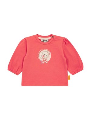 Coral long-sleeve cotton top with puffed sleeves, featuring a bear graphic and text "I love sweet cherries," with a logo tag on the side.
